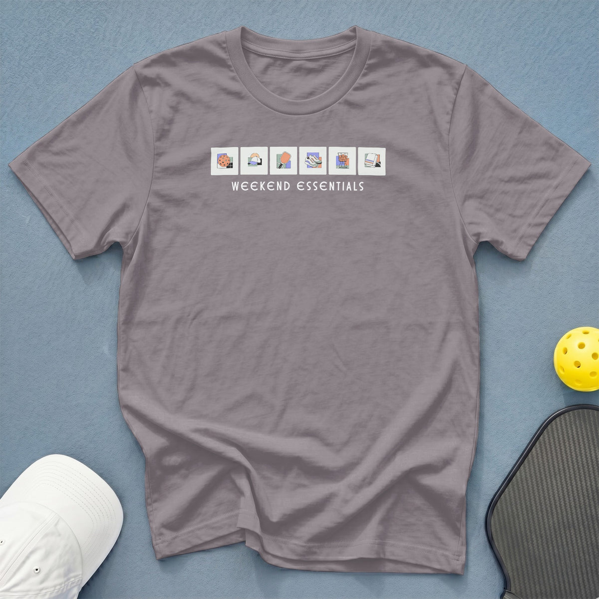 Grey t-shirt with "Weekend Essentials" text and icons.