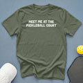 Olive green t-shirt with white text "MEET ME AT THE PICKLEBALL COURT".