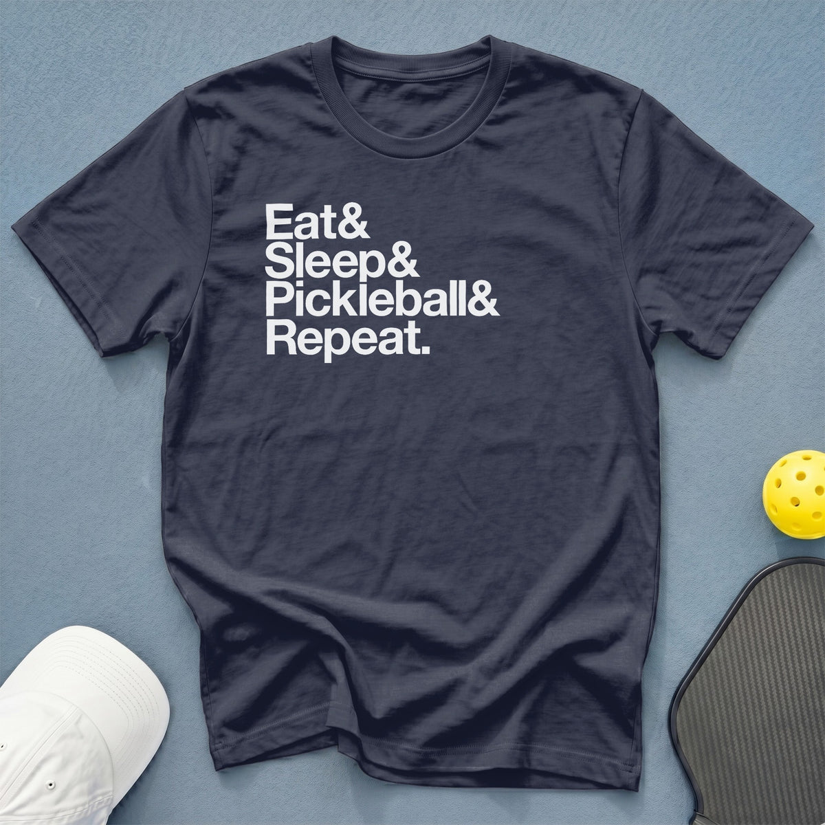 Navy t-shirt with white text "Eat & Sleep & Pickleball & Repeat."