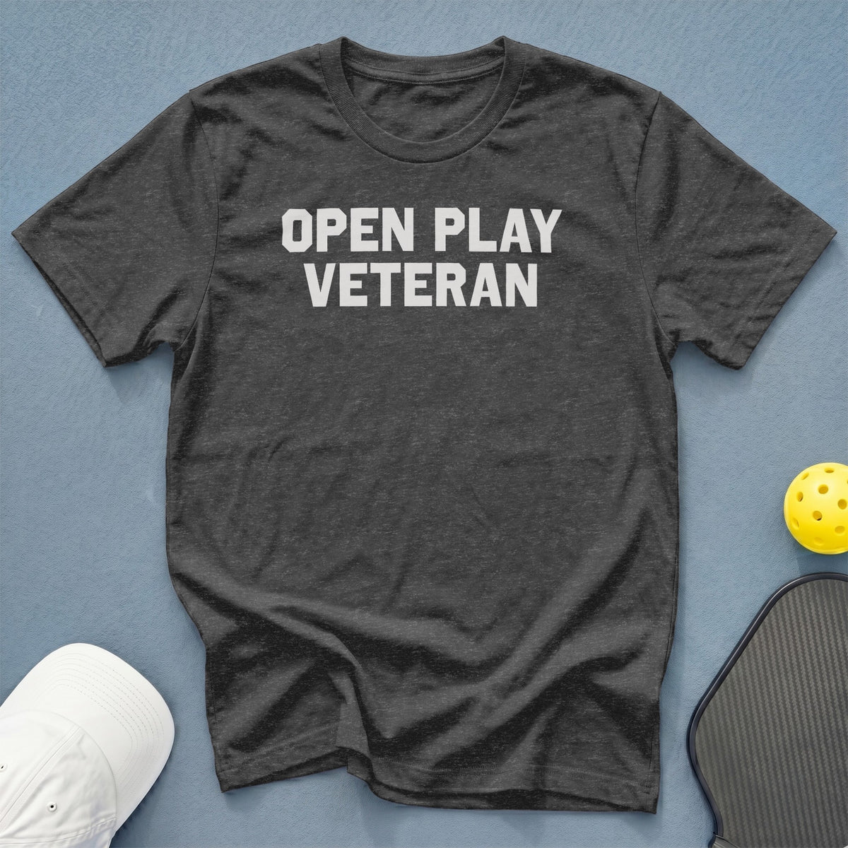 Dark gray t-shirt with white text "OPEN PLAY VETERAN"