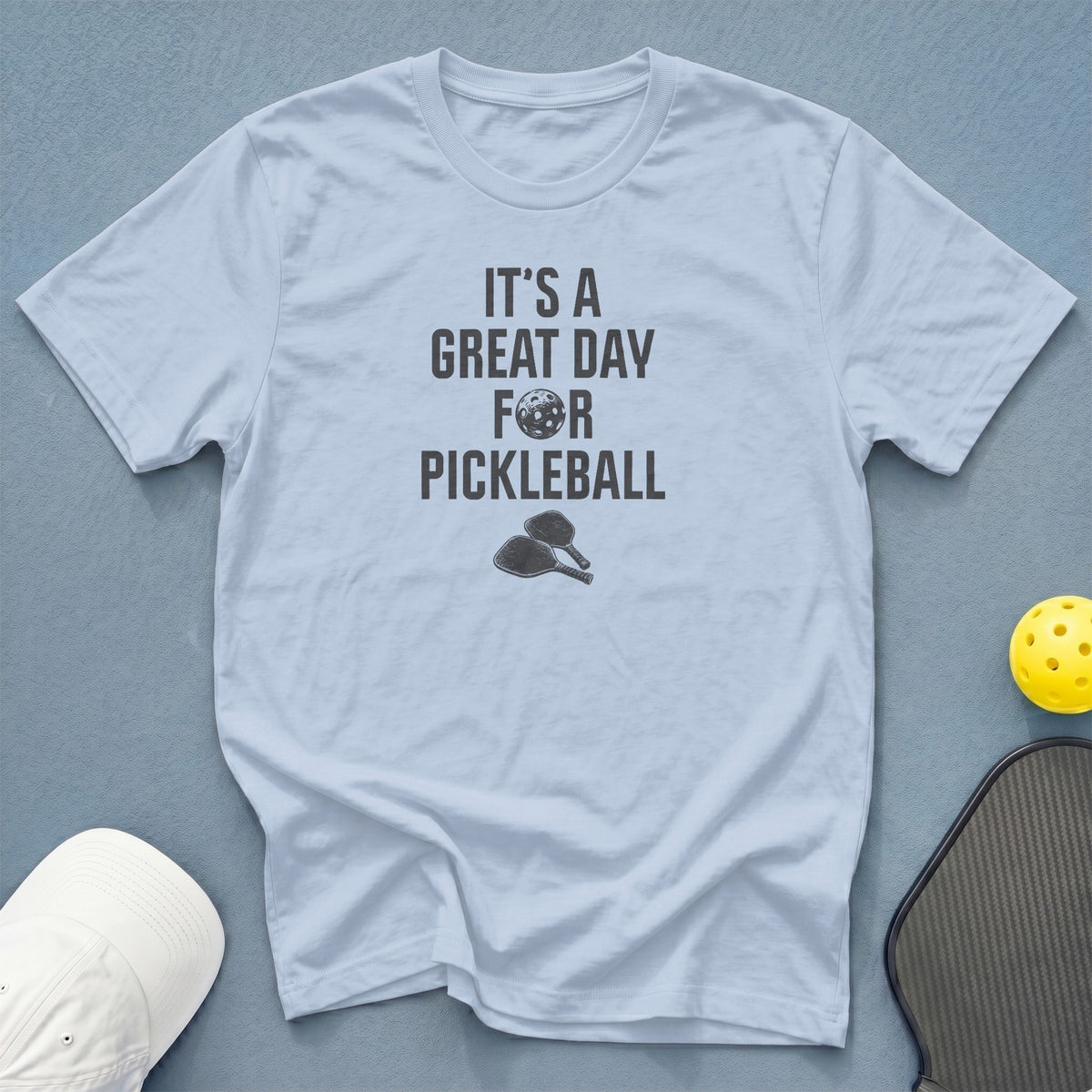 Light blue t-shirt with "It's a Great Day For Pickleball" text and graphics.