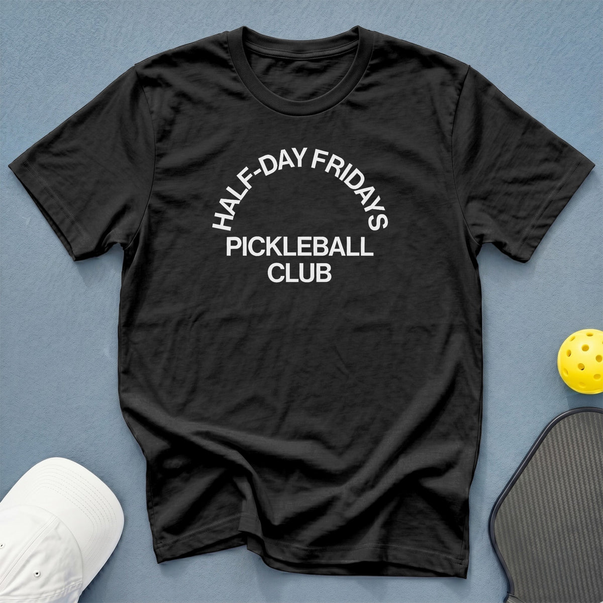 Black t-shirt with "Half-Day Fridays Pickleball Club" text, pickleball, and paddle.