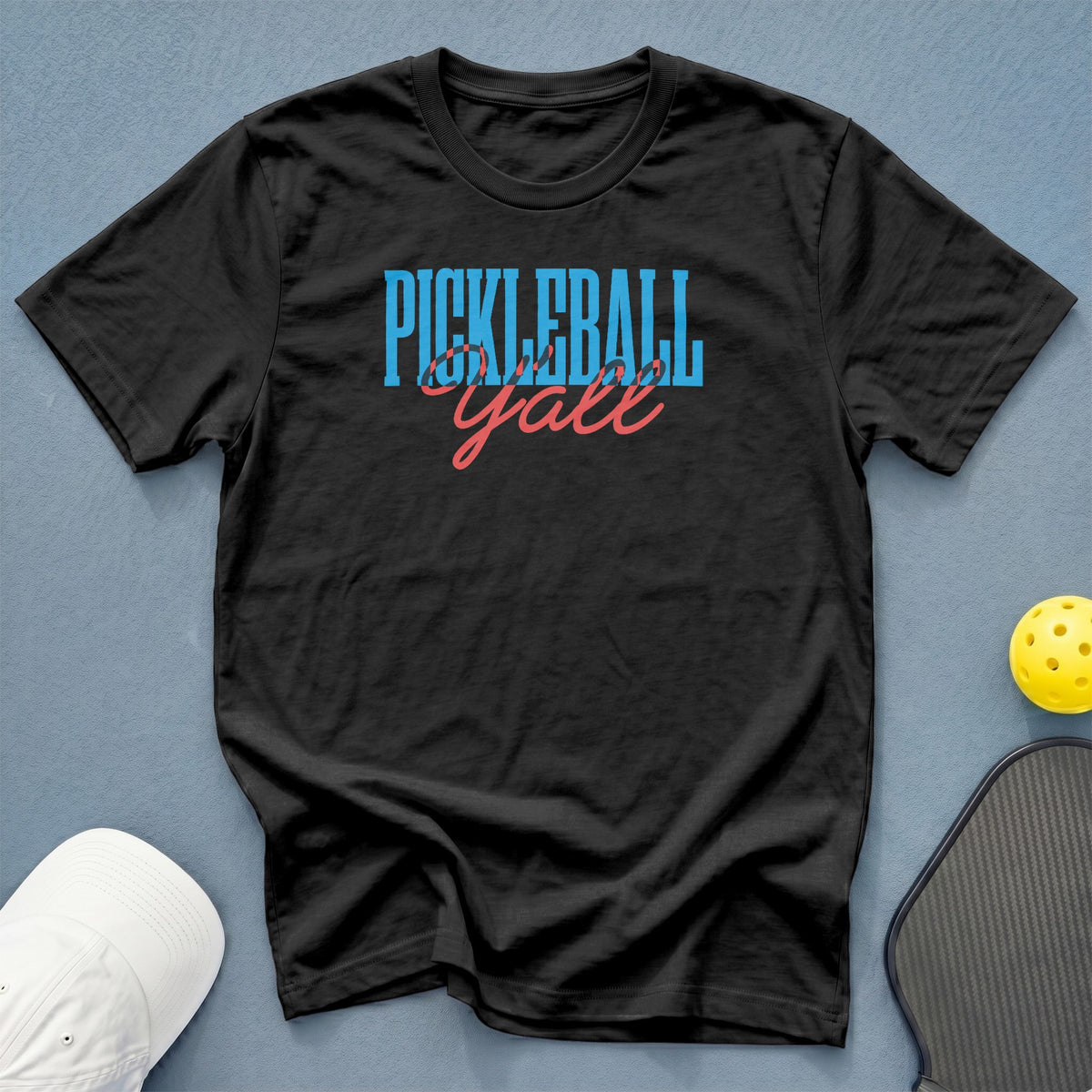 Black t-shirt with "Pickleball Y'all" text, pickleball, and paddle.
