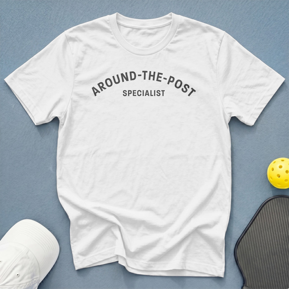 White t-shirt with "AROUND-THE-POST SPECIALIST" text, pickleball paddle, and yellow ball.