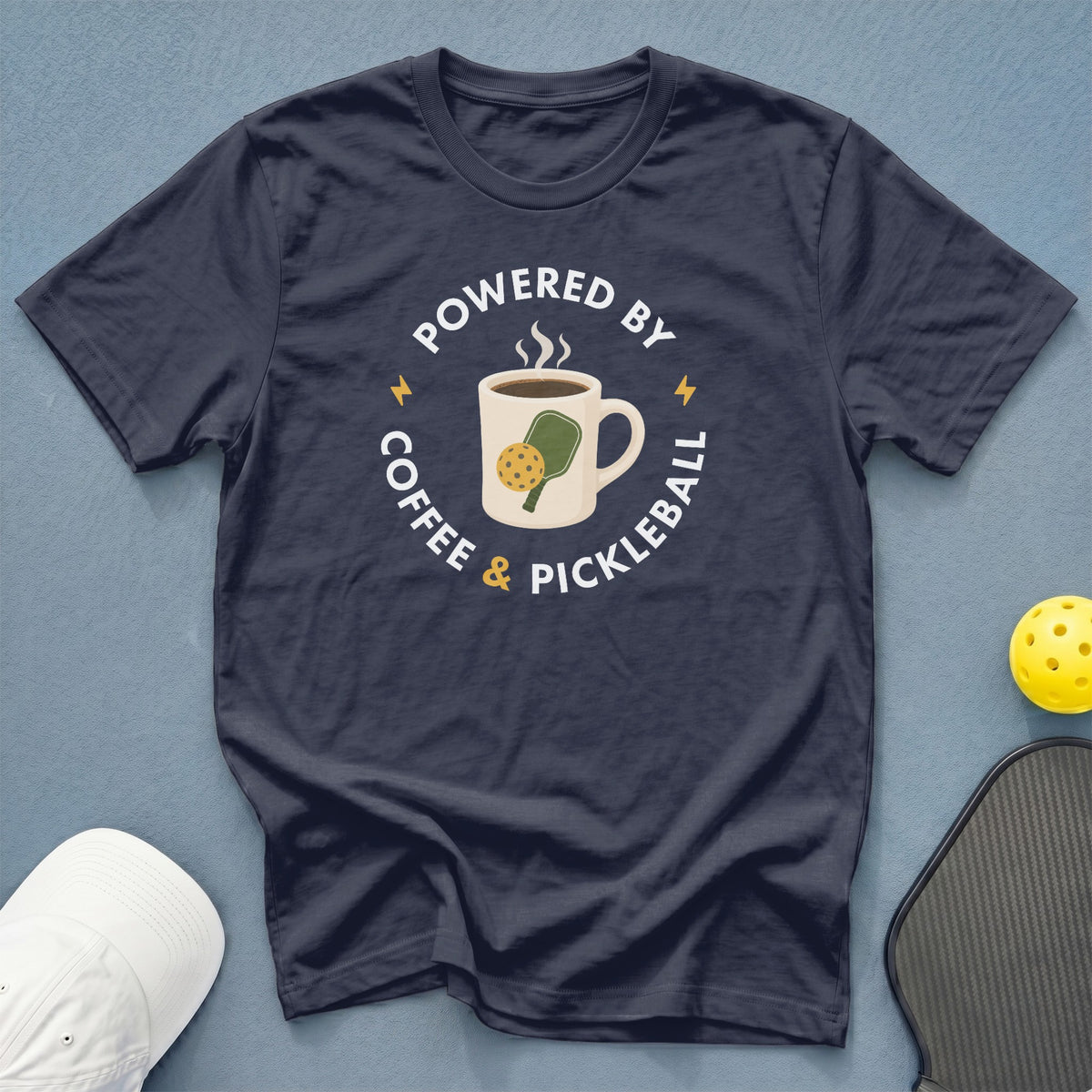 Navy t-shirt with "Powered by Coffee & Pickleball" text and graphic.