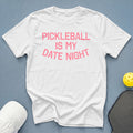 White t-shirt with pink text that reads "PICKLEBALL IS MY DATE NIGHT".