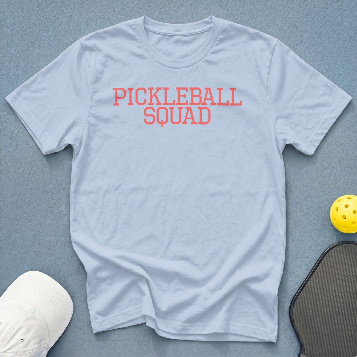Light blue t-shirt with "PICKLEBALL SQUAD" in coral text.