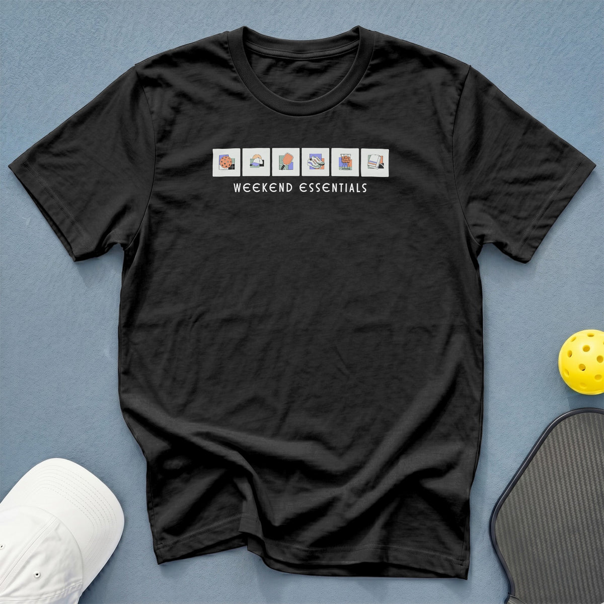 Black t-shirt with "WEEKEND ESSENTIALS" text and icons of weekend activities.