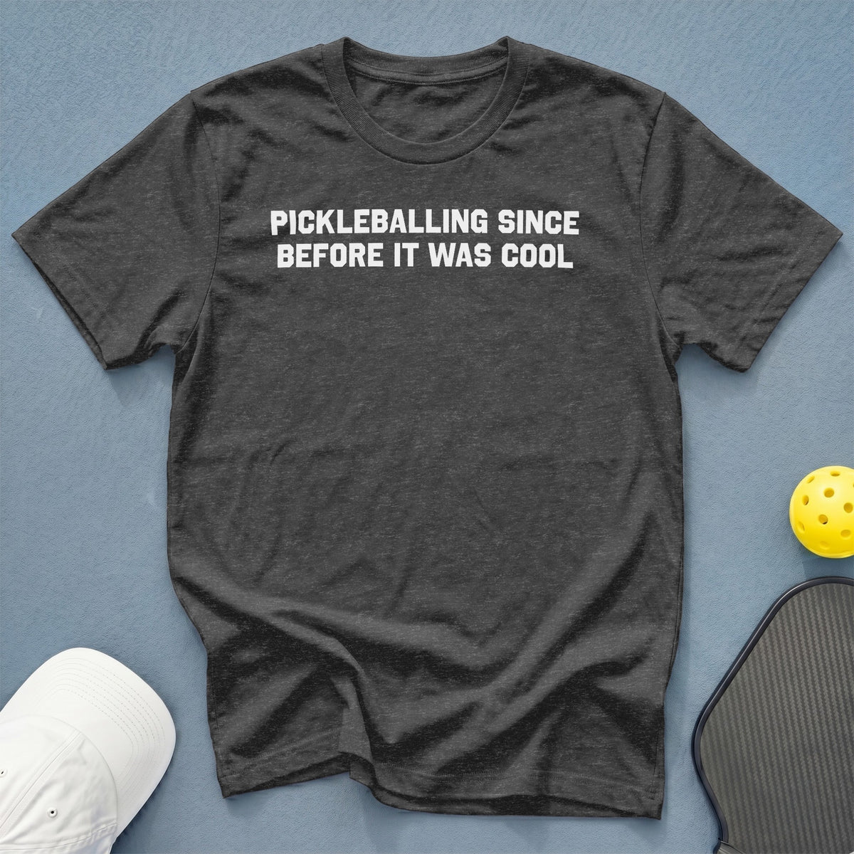 Dark grey t-shirt with white text reading "Pickleballing Since Before It Was Cool".