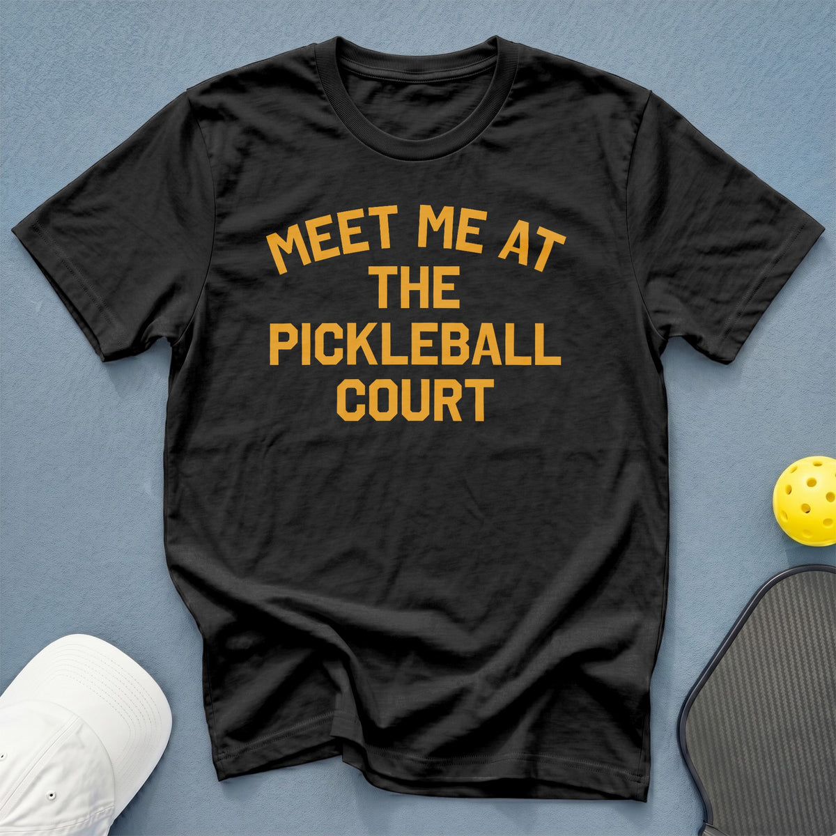 Black t-shirt with orange text "Meet Me At The Pickleball Court".