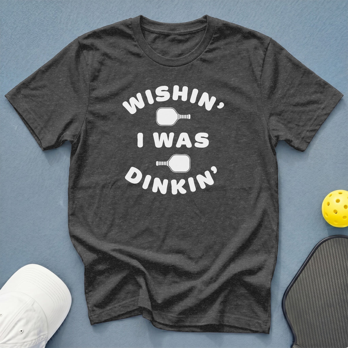 Dark grey t-shirt with "Wishin, I was dinkin'" text and pickleball graphics.