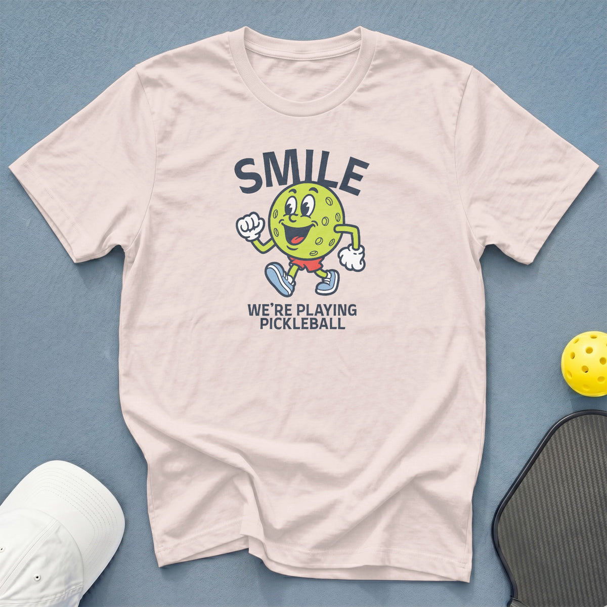T-shirt with "SMILE WE'RE PLAYING PICKLEBALL" and a pickleball character graphic.