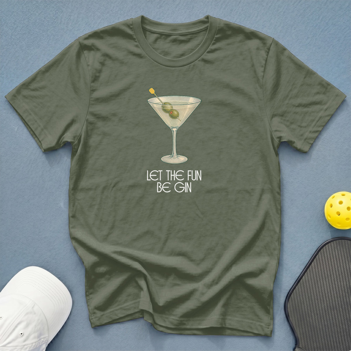 Green t-shirt with a martini glass graphic and text "LET THE FUN BE GIN."