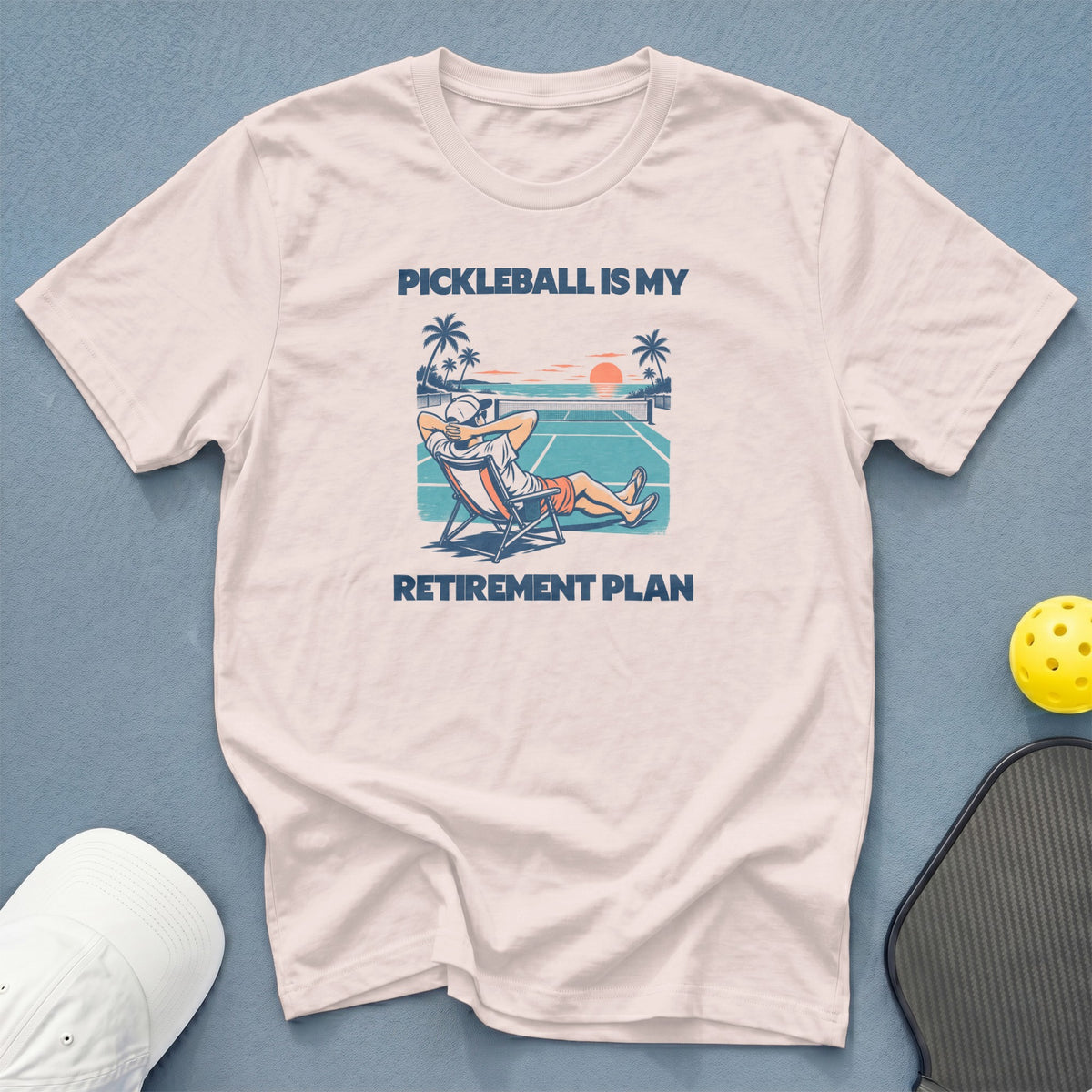 White t-shirt with "Pickleball is my retirement plan" text and illustration.