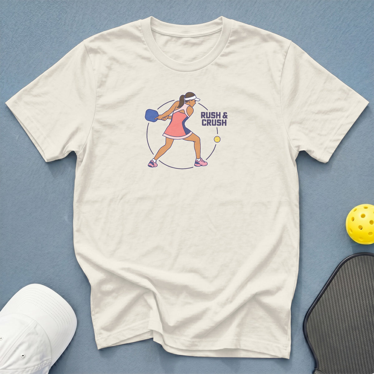 Cream t-shirt with pickleball graphic and text "RUSH & CRUSH"