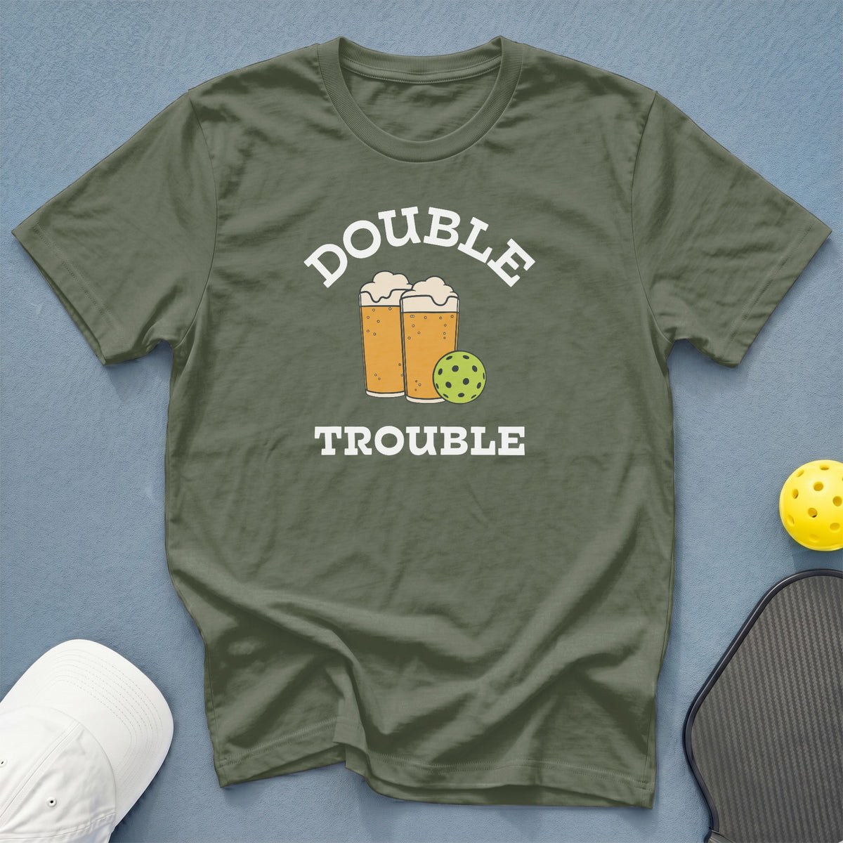 Olive t-shirt with "DOUBLE TROUBLE" text, beer mugs, and pickleball graphic.