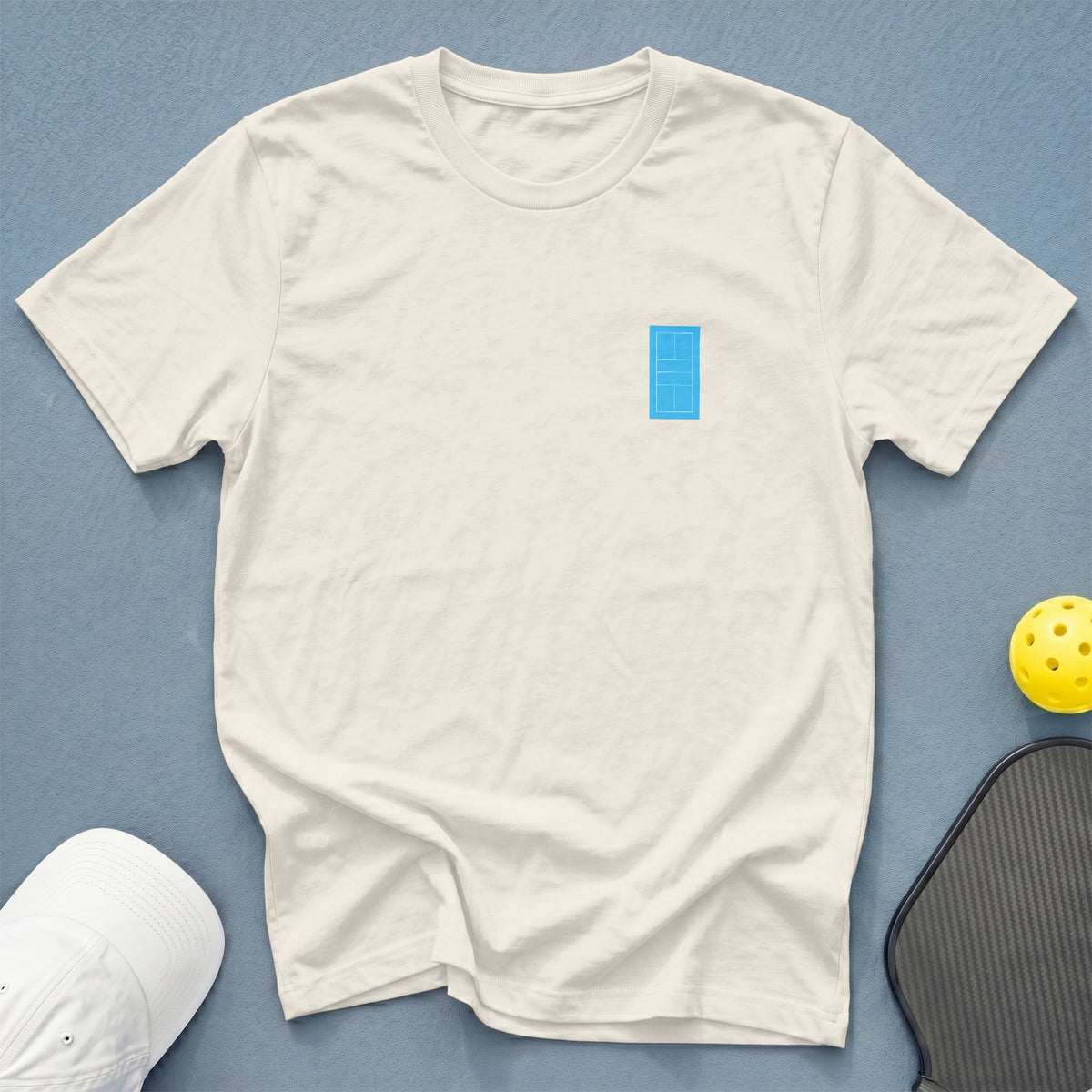 White t-shirt with a blue pickleball court graphic on the left chest.
