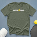 Olive green t-shirt with white "Pickle Ball" text and pickleball graphic.