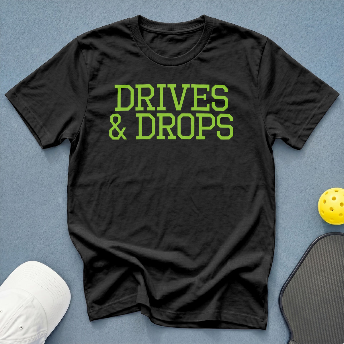 Black t-shirt with "DRIVES & DROPS" in lime green font.
