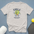 Light grey t-shirt with "SMILE WE'RE PLAYING PICKLEBALL" text and pickleball graphic.
