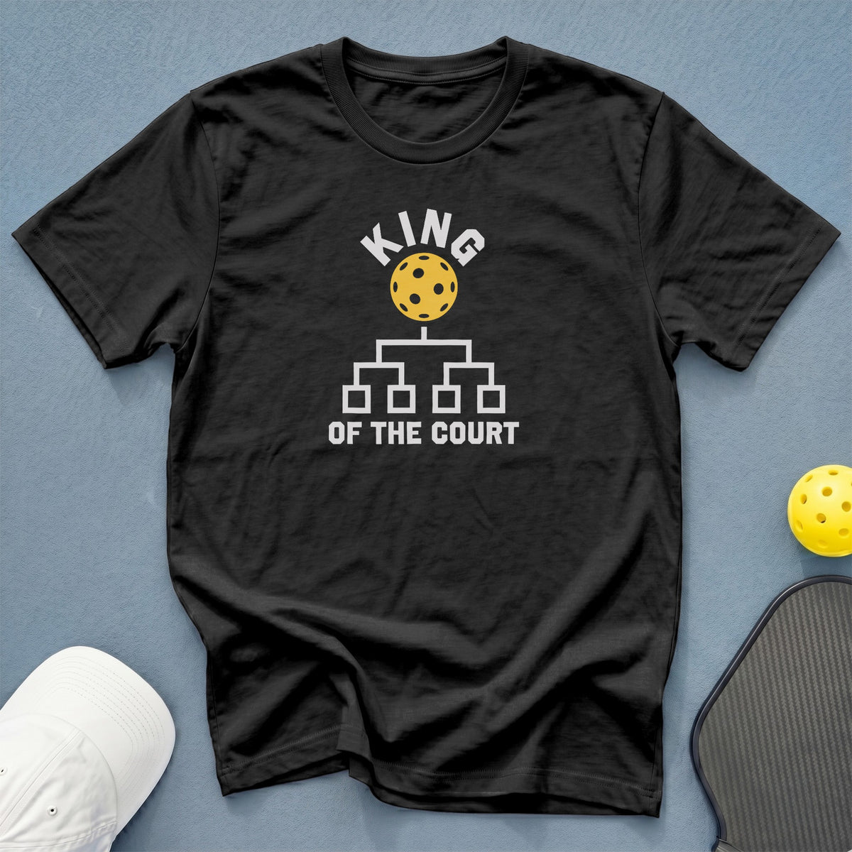 Black t-shirt with yellow pickleball and "King of the Court" text design.