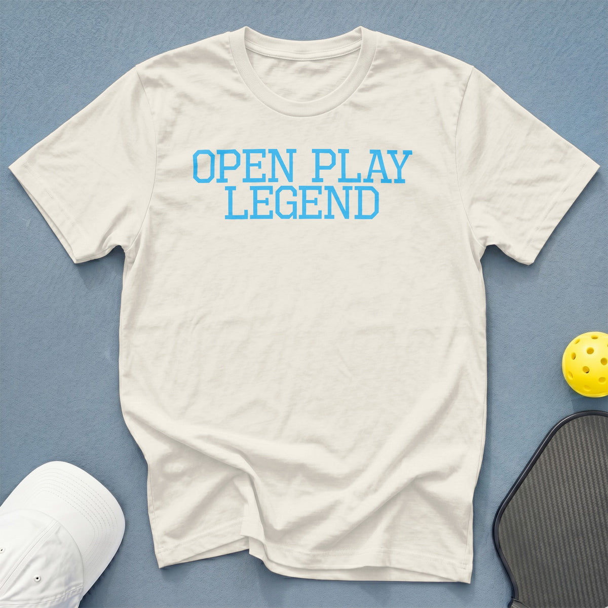 White t-shirt with blue text "OPEN PLAY LEGEND".