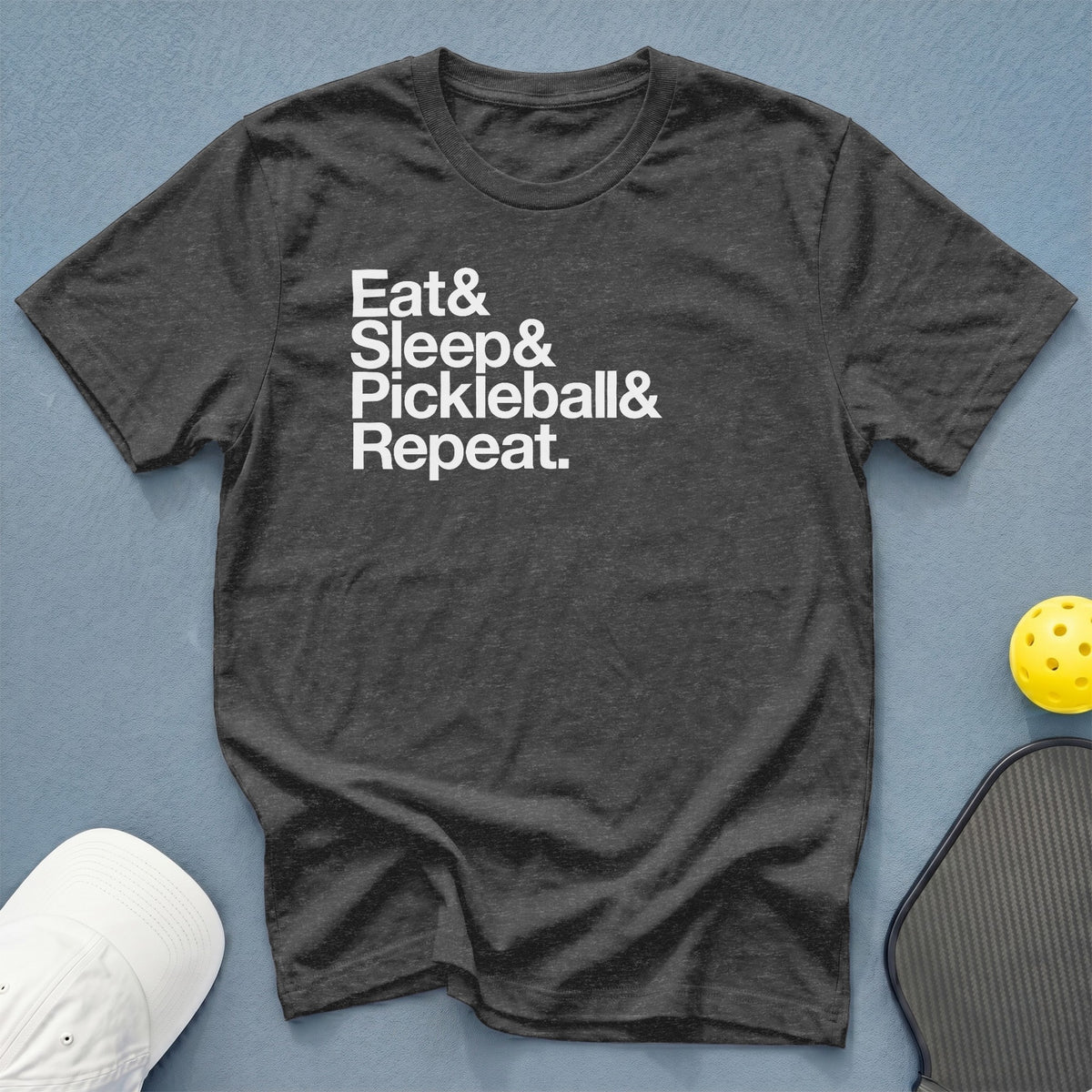 Dark gray t-shirt with white text "Eat & Sleep & Pickleball & Repeat."