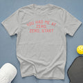 Light grey t-shirt with pink text "YOU HAD ME AT ZERO, ZERO, START".