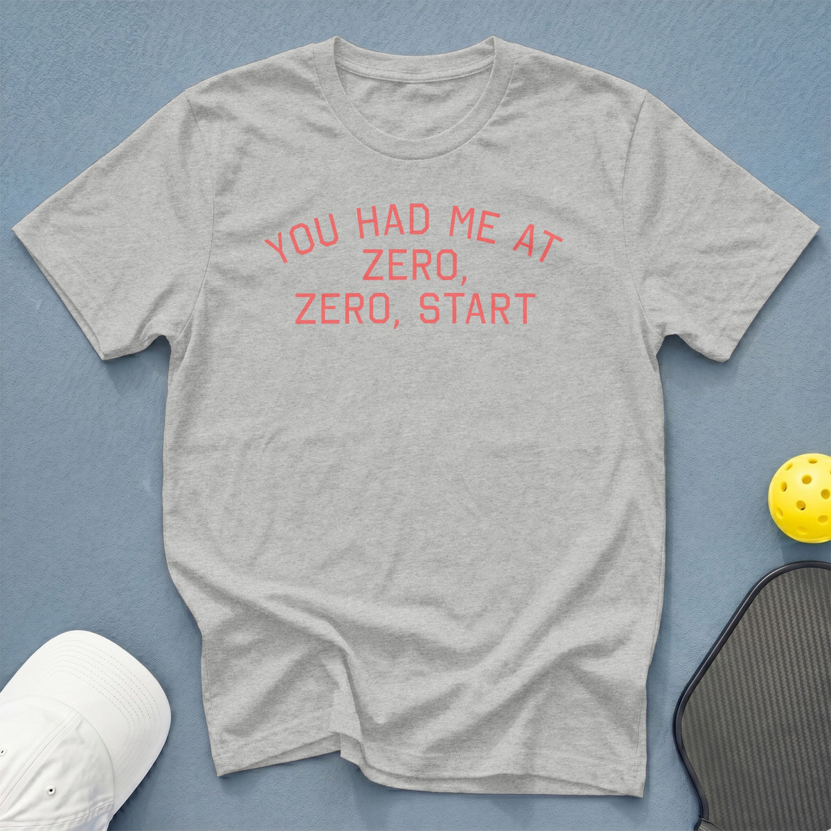 Light grey t-shirt with pink text "YOU HAD ME AT ZERO, ZERO, START".