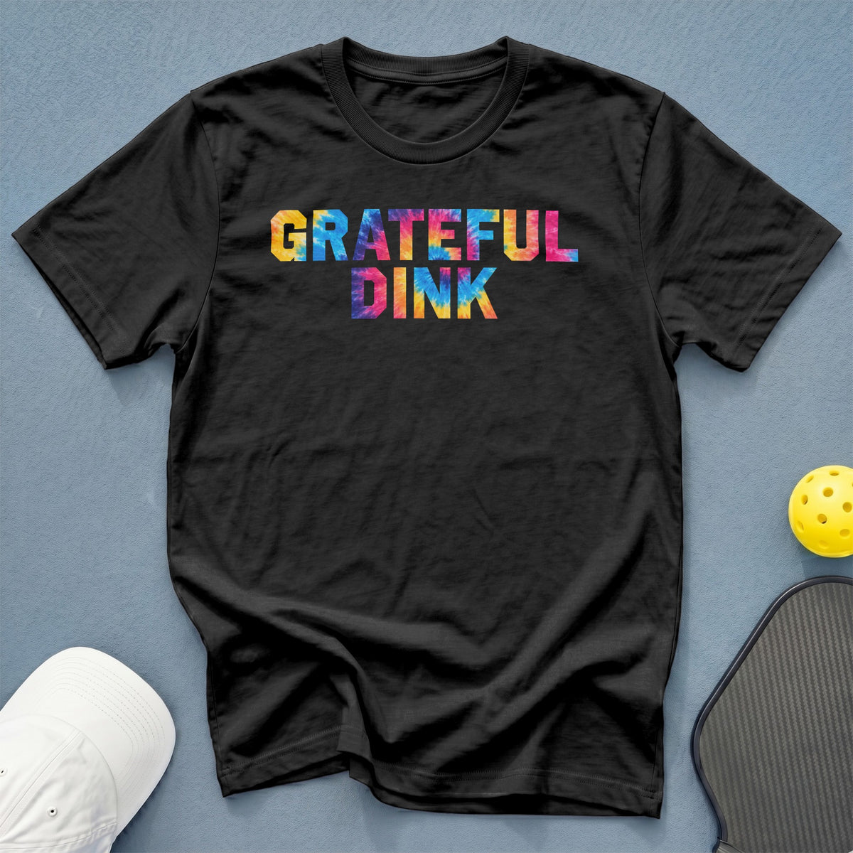 Black t-shirt with "GRATEFUL DINK" in colorful tie-dye letters.