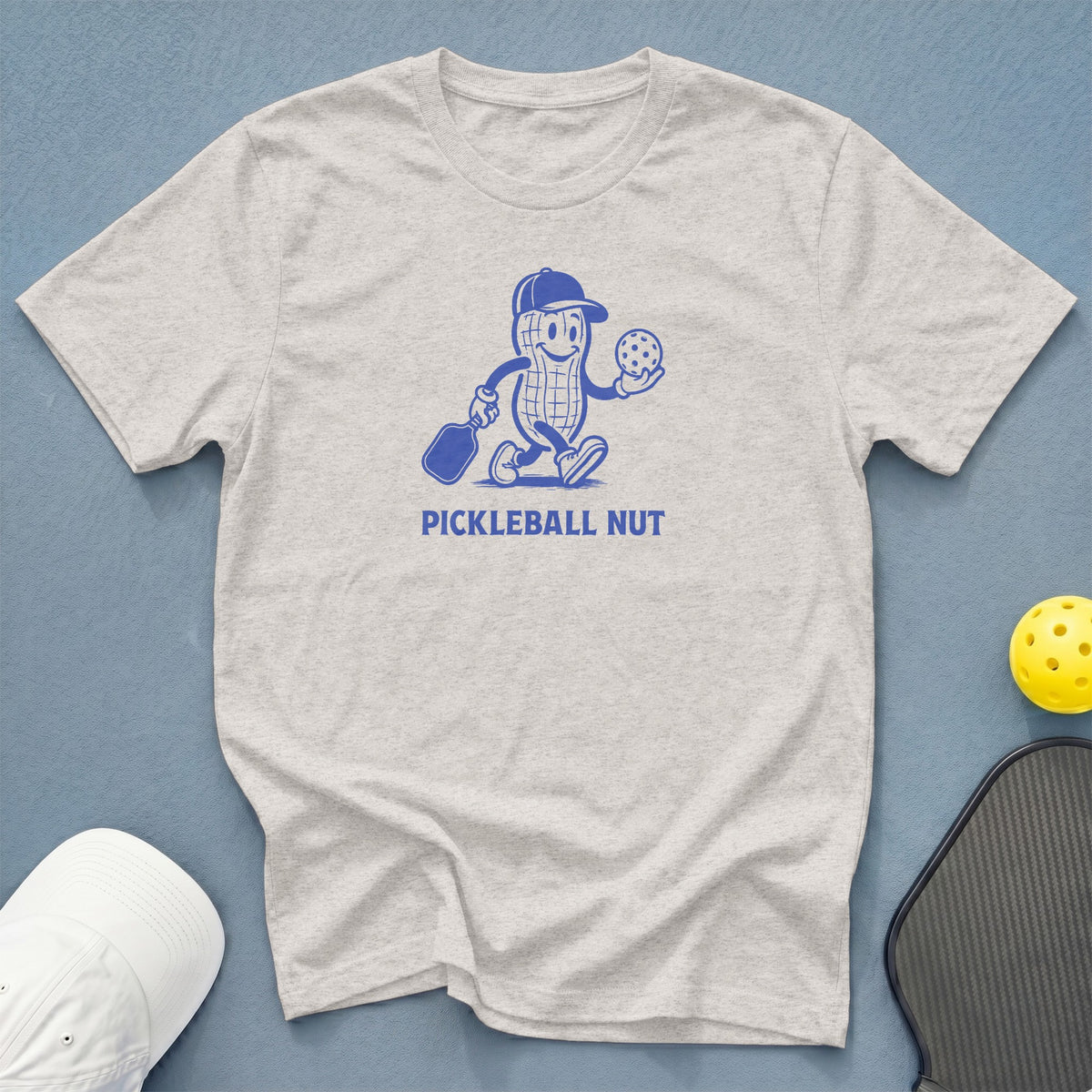 Light gray t-shirt with a blue pickleball graphic and text "PICKLEBALL NUT".