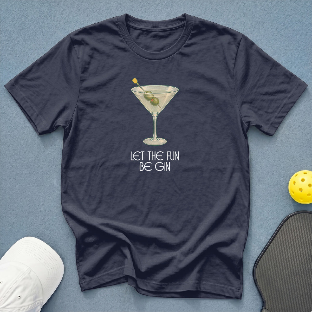 Navy t-shirt with a martini glass graphic and text "LET THE FUN BE GIN."