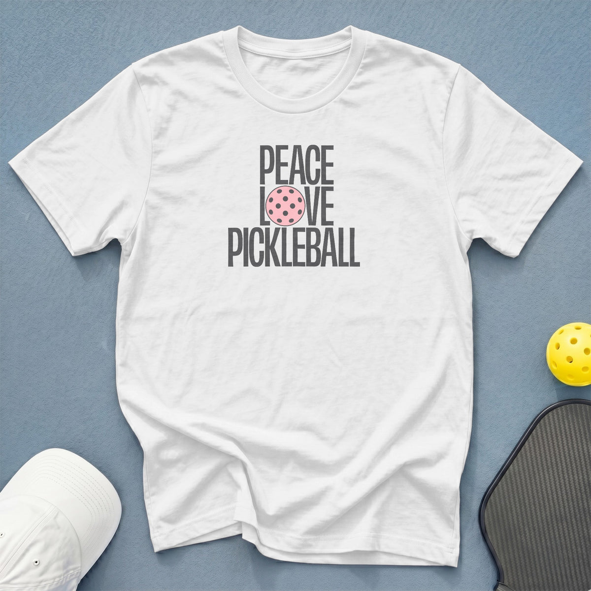White t-shirt with "PEACE LOVE PICKLEBALL" graphic, pickleball, and paddle.