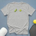 Gray t-shirt with a pickle and pickleball graphic and accessories.