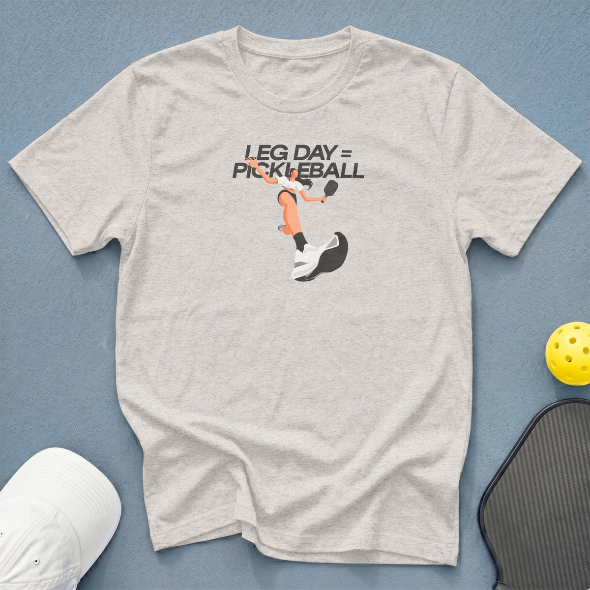 Light gray t-shirt with "Leg Day = Pickleball" graphic and pickleball gear.