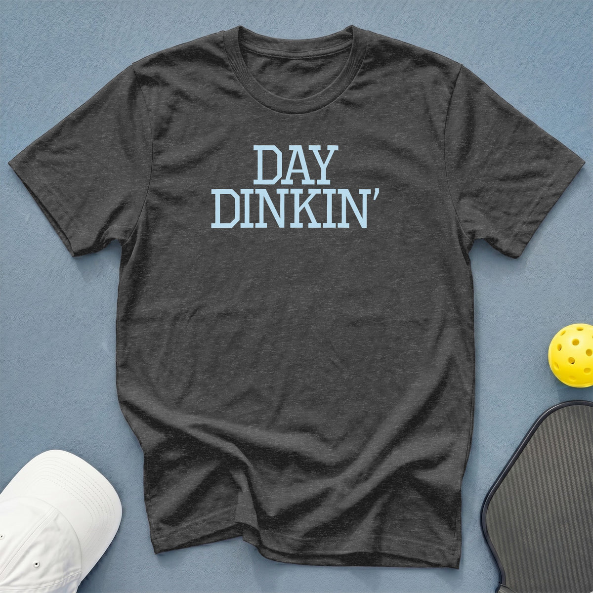Dark grey t-shirt with "DAY DINKIN'" text, pickleball paddle and ball.