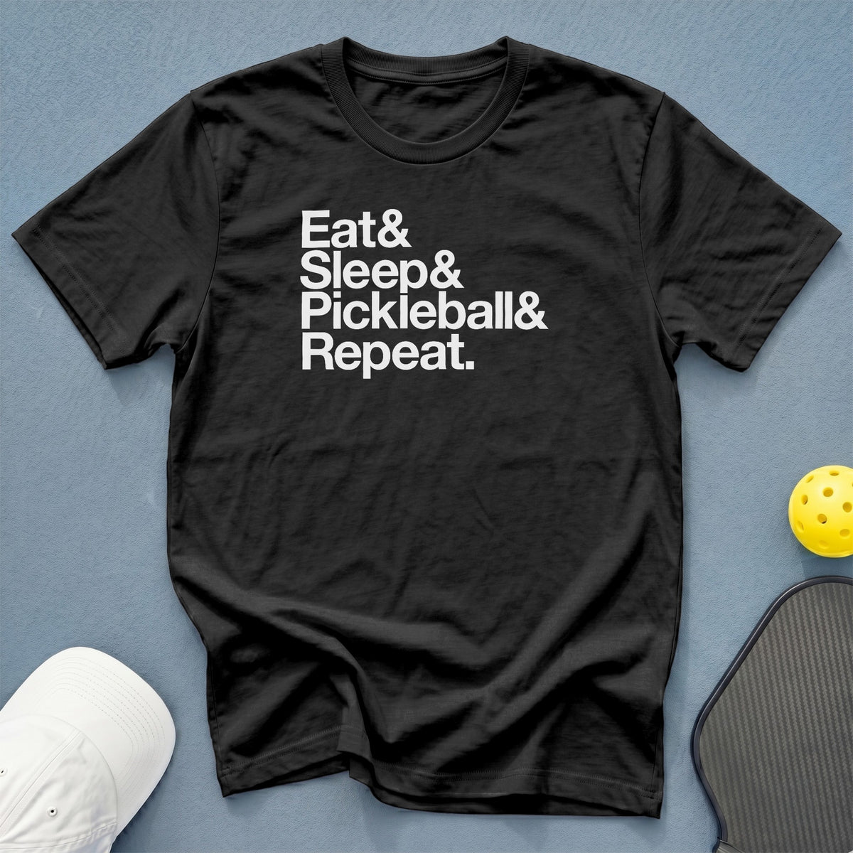 Black t-shirt with white text: Eat & Sleep & Pickleball & Repeat.