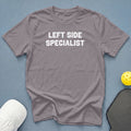 Gray t-shirt with "LEFT SIDE SPECIALIST" text, white hat, pickleball paddle, and yellow ball.
