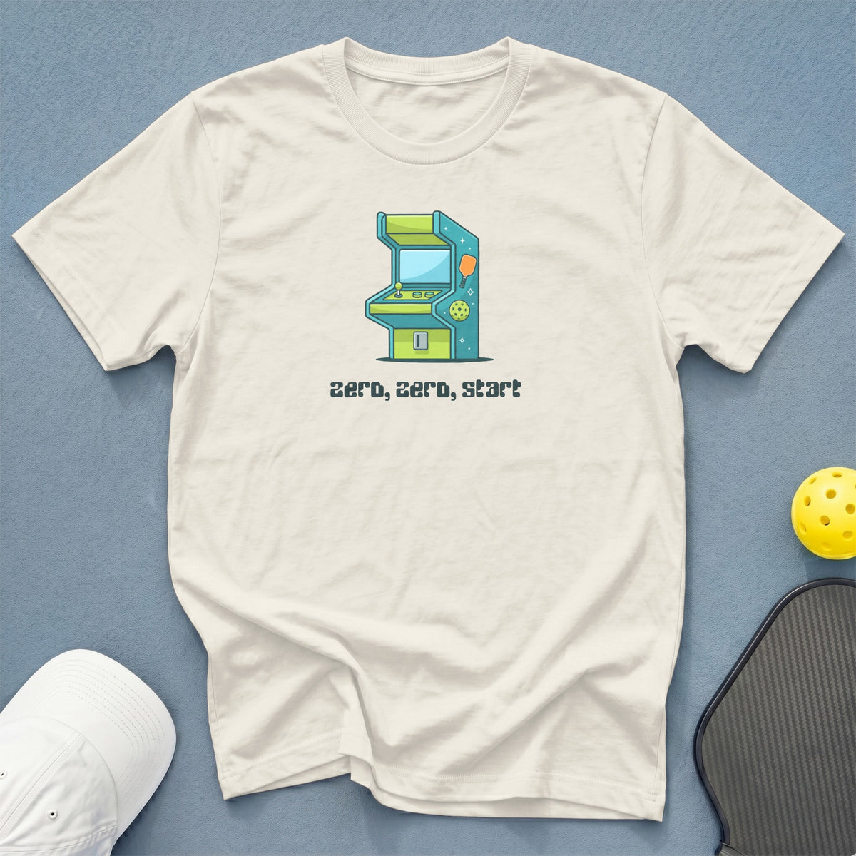 Cream t-shirt with cartoon arcade game and text "zero, zero, start".