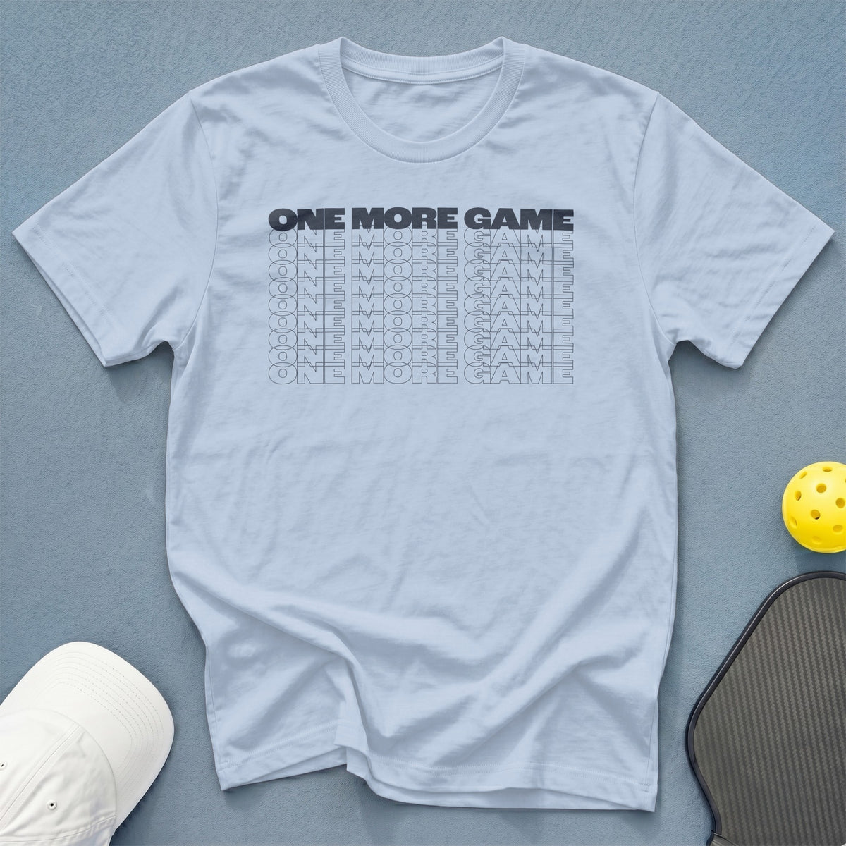 Light blue t-shirt with "ONE MORE GAME" repeated in black text.