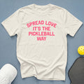 White t-shirt with pink text "Spread Love It's The Pickleball Way."