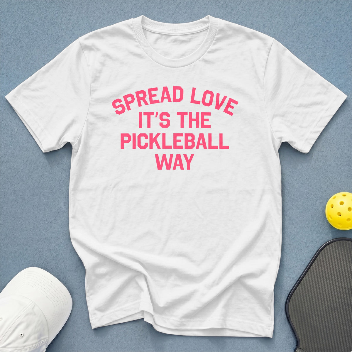 White t-shirt with pink text that says "SPREAD LOVE IT'S THE PICKLEBALL WAY".