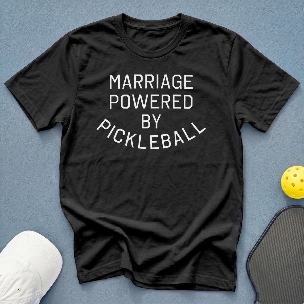 Black t-shirt with white text reading "MARRIAGE POWERED BY PICKLEBALL"
