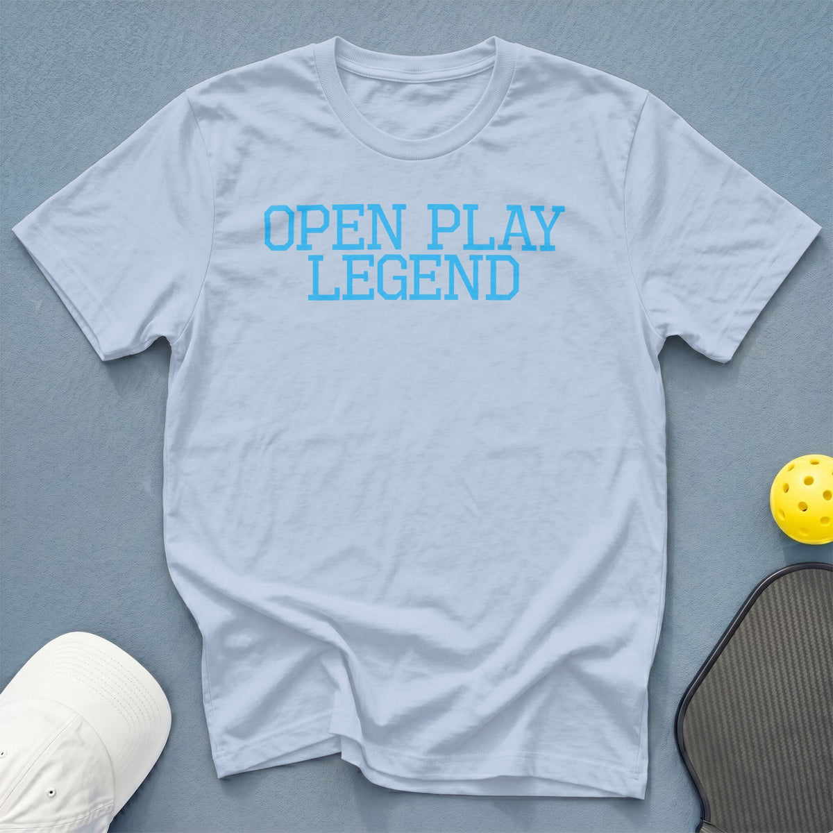 Light blue t-shirt with "OPEN PLAY LEGEND" text in blue.